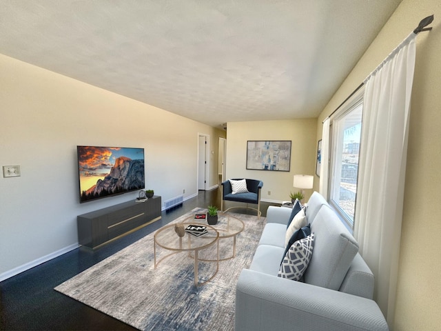 living room with visible vents and baseboards