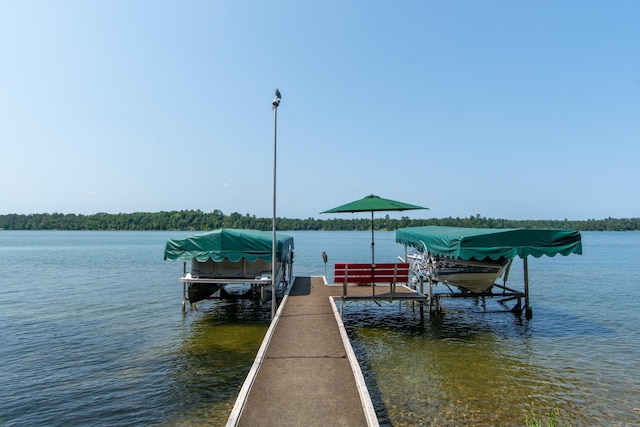 dock area with a water view and boat lift