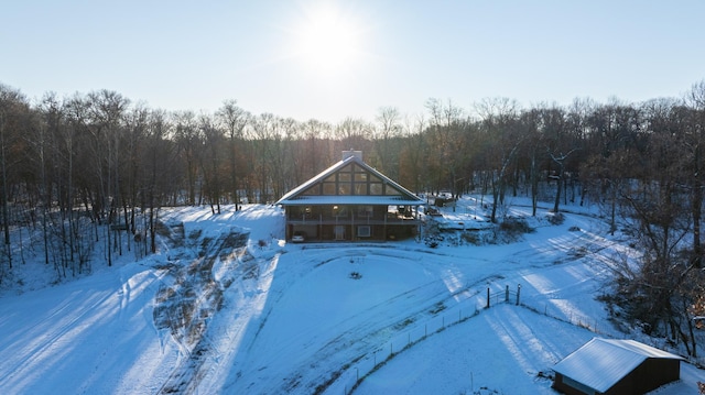 snowy aerial view with a forest view