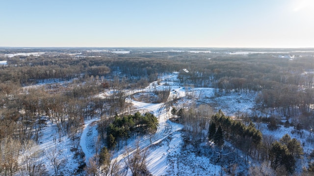 snowy aerial view with a forest view