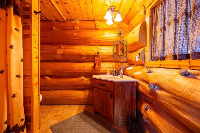 bathroom featuring wood ceiling, tile patterned flooring, rustic walls, and vanity