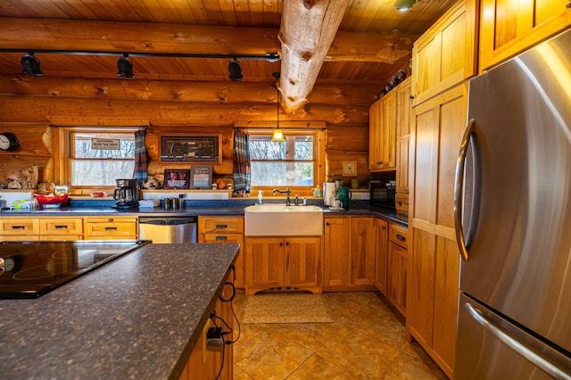 kitchen with beam ceiling, stainless steel appliances, rail lighting, a sink, and wooden ceiling