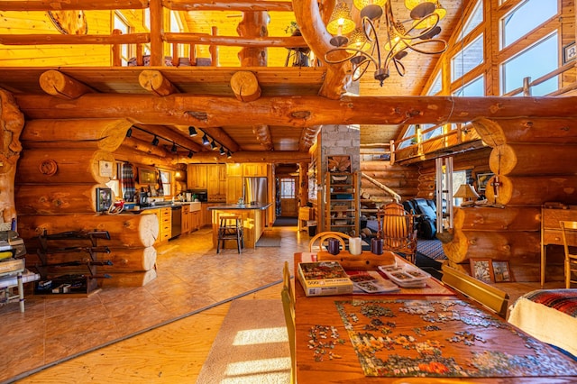 dining room featuring beam ceiling, rustic walls, rail lighting, wood ceiling, and high vaulted ceiling