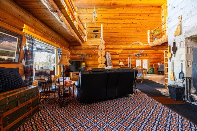 living area with a towering ceiling, wooden ceiling, log walls, and beam ceiling