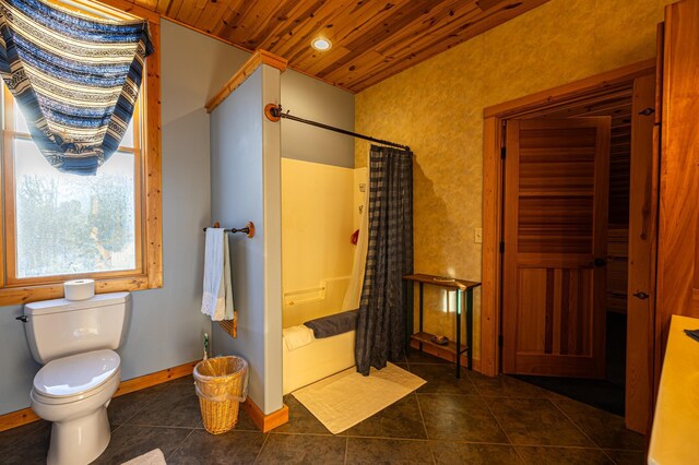 full bathroom with curtained shower, toilet, wood ceiling, tile patterned flooring, and baseboards