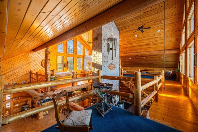 bedroom featuring high vaulted ceiling, wood walls, wood-type flooring, and wood ceiling