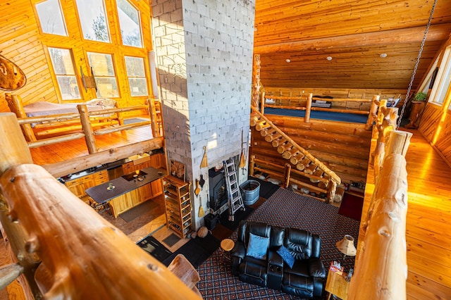 17910 27th Ave, Fair Haven Twp, MN 55320 - living area featuring log walls, vaulted ceiling, wood finished floors, wooden walls, and wood ceiling