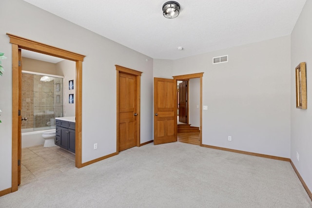 unfurnished bedroom with light carpet, visible vents, and baseboards