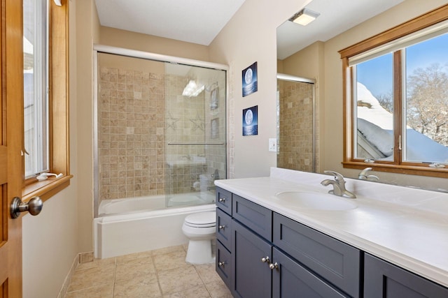 full bath featuring toilet, shower / bath combination with glass door, tile patterned flooring, baseboards, and vanity