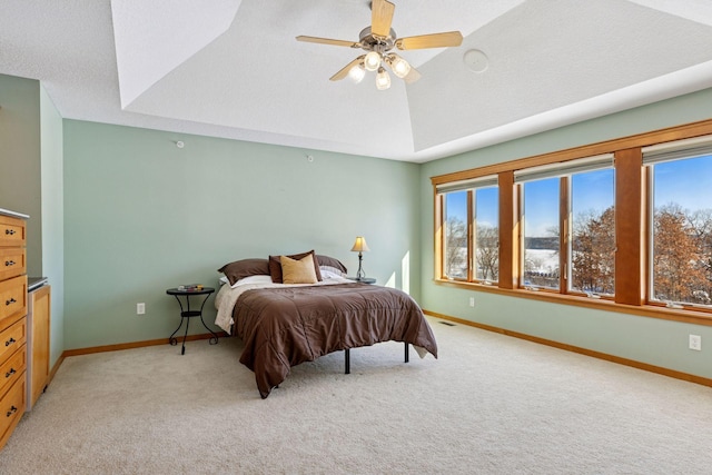 bedroom featuring multiple windows, light carpet, and baseboards