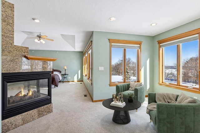 bedroom featuring visible vents, baseboards, carpet flooring, recessed lighting, and a tile fireplace