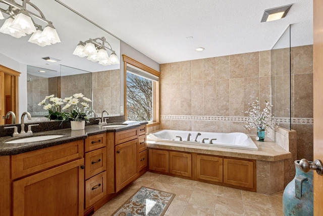 full bathroom featuring tile walls, a garden tub, and a sink