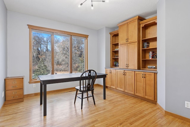 office space featuring light wood-style flooring and baseboards