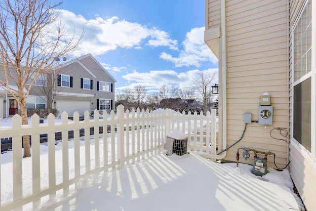 snow covered patio with fence