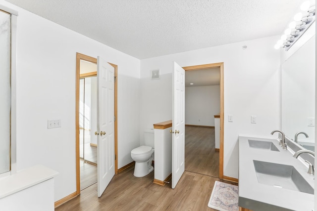 full bath with visible vents, a sink, toilet, and wood finished floors