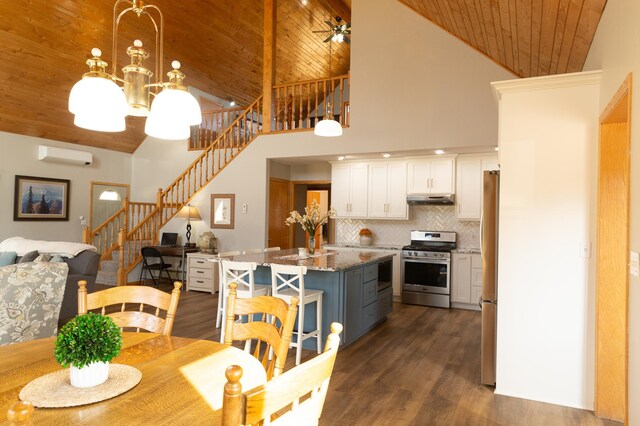dining area with wooden ceiling, stairway, high vaulted ceiling, a wall unit AC, and dark wood-style floors
