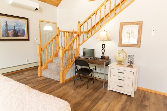 staircase featuring a baseboard heating unit, wood finished floors, a wall unit AC, baseboards, and vaulted ceiling