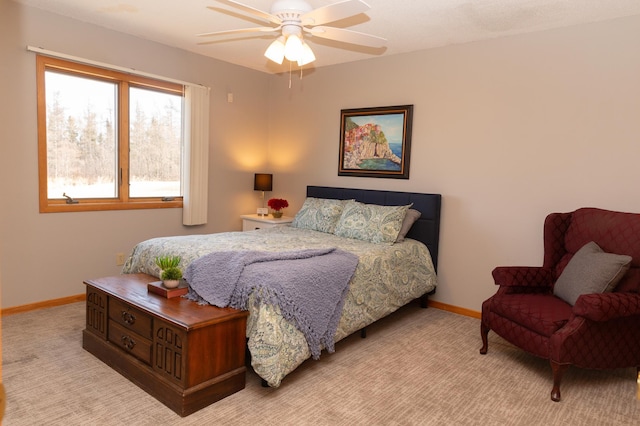 carpeted bedroom featuring baseboards and a ceiling fan