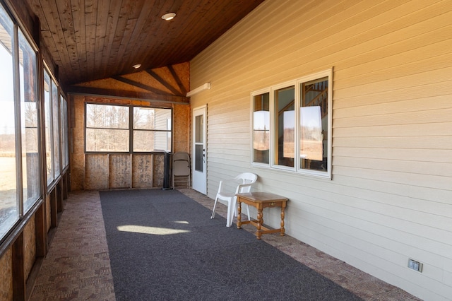sunroom / solarium featuring lofted ceiling