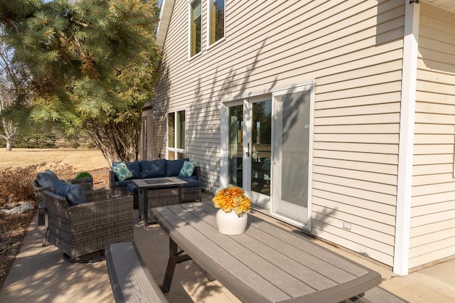 wooden deck featuring an outdoor hangout area and a patio area