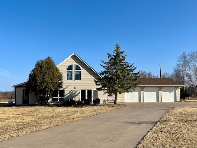 view of front of home featuring concrete driveway and an attached garage