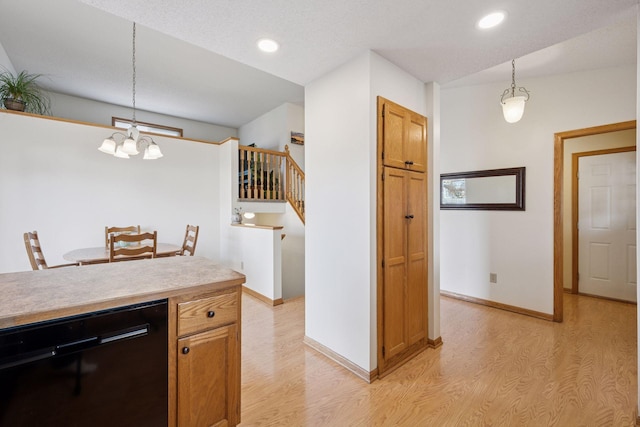 kitchen with dishwasher, light wood-style flooring, baseboards, and pendant lighting