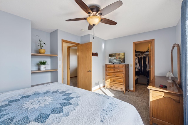 bedroom featuring visible vents, a closet, carpet floors, ceiling fan, and a spacious closet