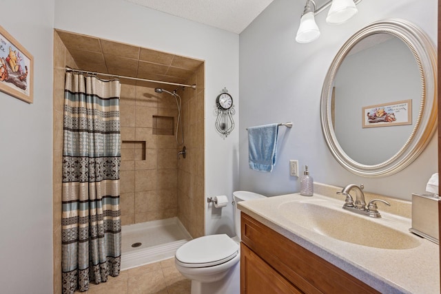 full bath featuring tile patterned flooring, toilet, vanity, a tile shower, and a textured ceiling