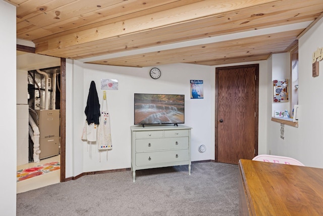 carpeted bedroom featuring heating unit, wooden ceiling, baseboards, and vaulted ceiling