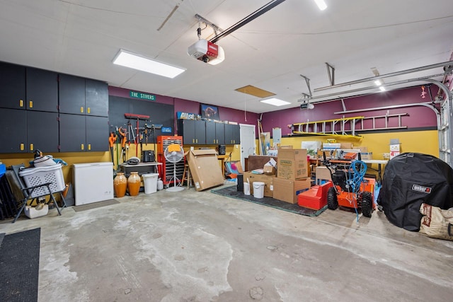 garage with a workshop area and a garage door opener