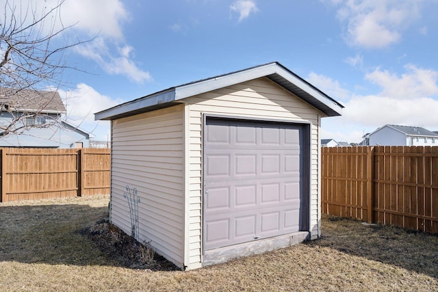 detached garage featuring fence