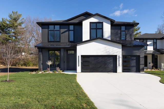 contemporary house with driveway, a garage, metal roof, a standing seam roof, and a front lawn