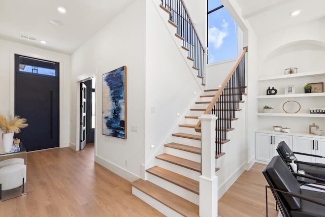 foyer entrance with light wood-style floors, recessed lighting, visible vents, and baseboards