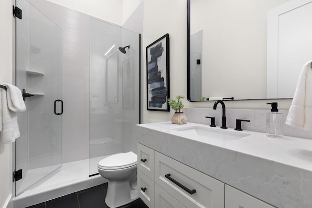 bathroom featuring tile patterned flooring, a shower stall, toilet, and vanity