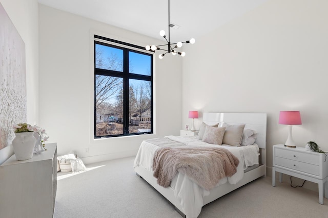 bedroom featuring carpet and a chandelier