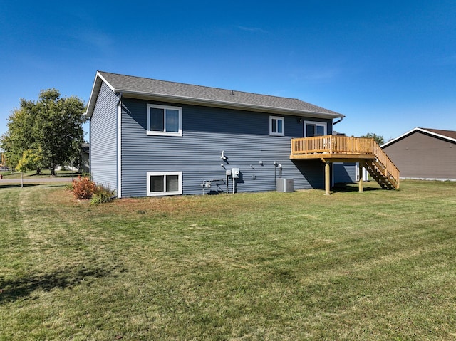 back of property with stairs, a lawn, and a wooden deck