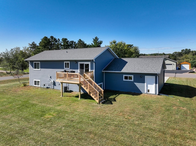 rear view of property with a deck, central AC, a yard, stairway, and roof with shingles