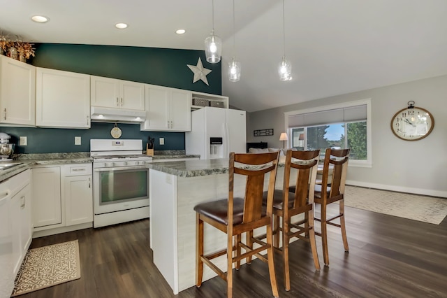 kitchen featuring white appliances, a center island, white cabinets, and under cabinet range hood