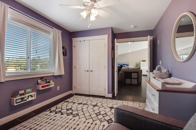 interior space featuring a closet, visible vents, a ceiling fan, wood finished floors, and baseboards