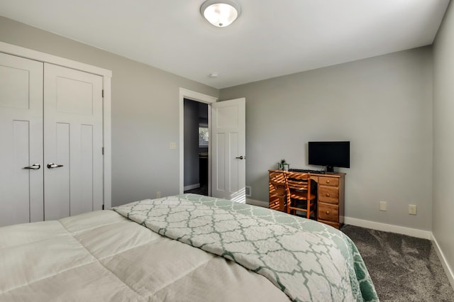 carpeted bedroom with a closet and baseboards