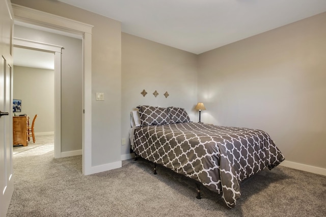 bedroom featuring carpet and baseboards