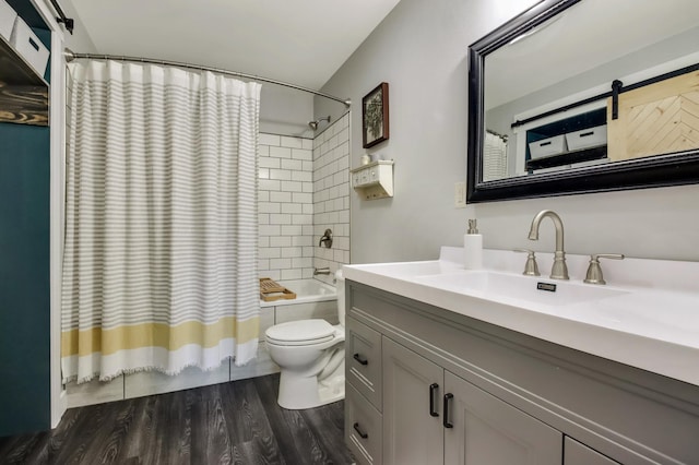 bathroom featuring vanity, wood finished floors, toilet, and shower / bathtub combination with curtain