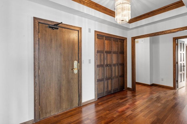 entrance foyer with baseboards, an inviting chandelier, and dark wood-style floors