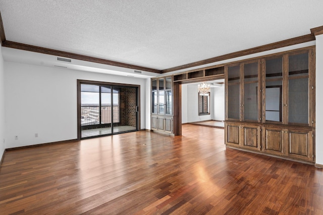 unfurnished living room with visible vents, baseboards, an inviting chandelier, a textured ceiling, and dark wood-style flooring