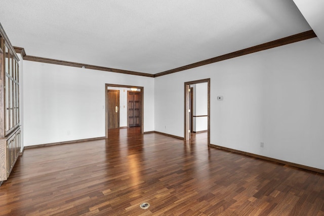 spare room featuring crown molding, wood finished floors, and baseboards