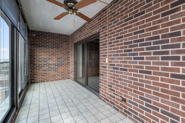 unfurnished sunroom with a ceiling fan