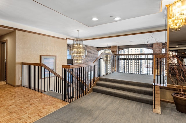 stairs featuring recessed lighting, baseboards, brick wall, and a chandelier