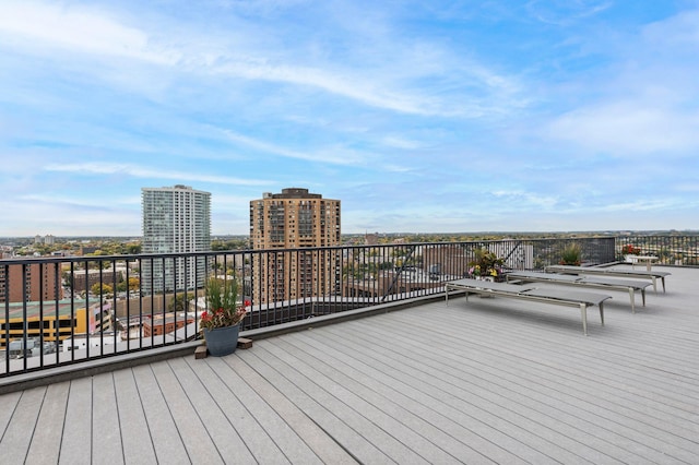 wooden terrace featuring a view of city