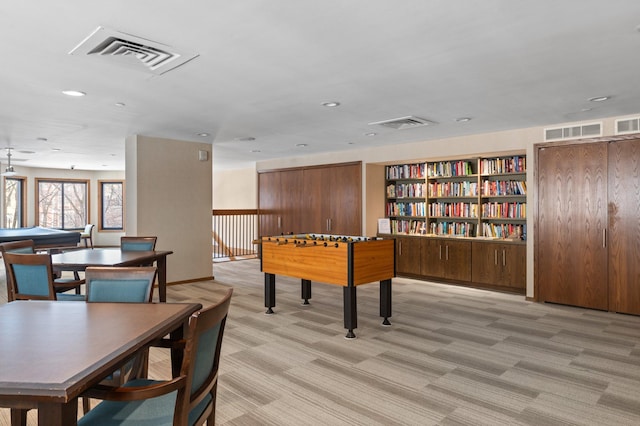 recreation room featuring visible vents and light carpet