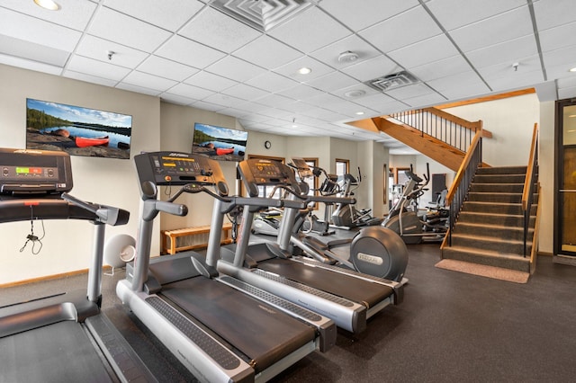 workout area featuring a drop ceiling, baseboards, and visible vents